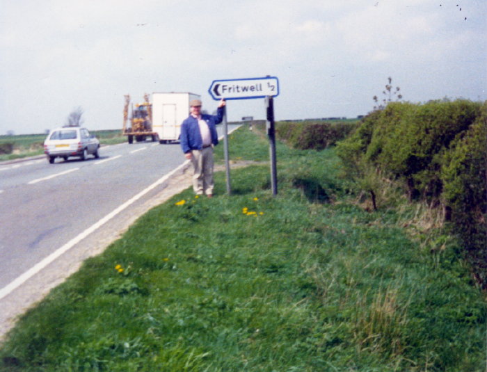 Bud Fretwell standing at Fritwell Village sign